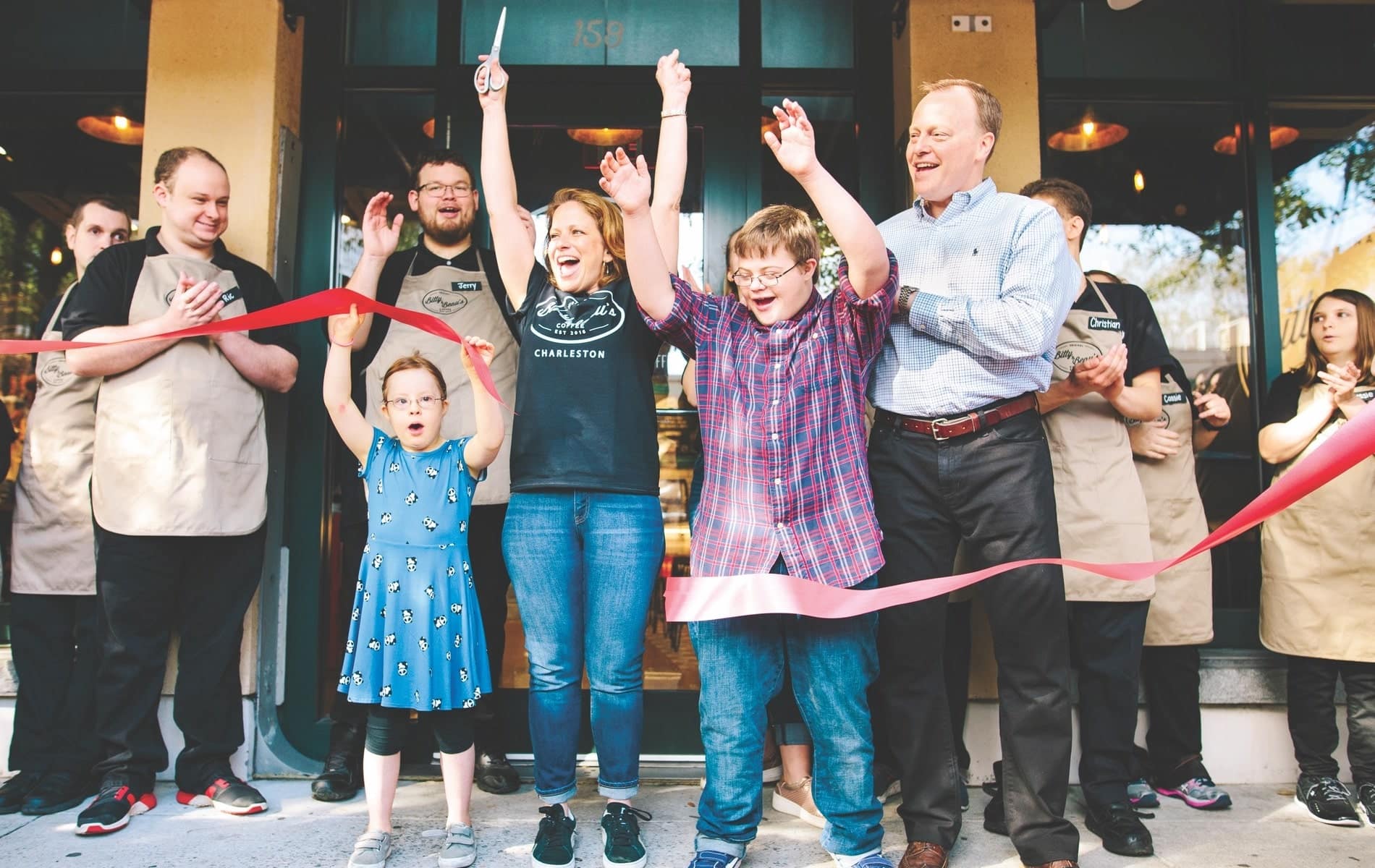 Wright family with a few employees standing on the sidewalk outside of the coffee shop at the Grand Opening for Bitty & Beau's Charleston location