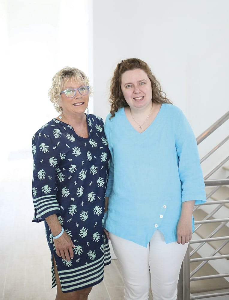 Camille and her mother, Brenda Nunnery posing by the staircase in their home in Florida