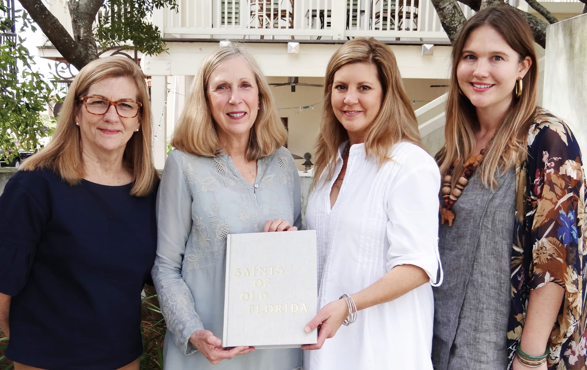Diane Brady (second from left) and Saints of Old Florida authors Christina McDermott, Melissa Farrell, and Emily Raffield holding the Saints of Old Florida book at the 2017 Rosemary Beach Girls Getaway.