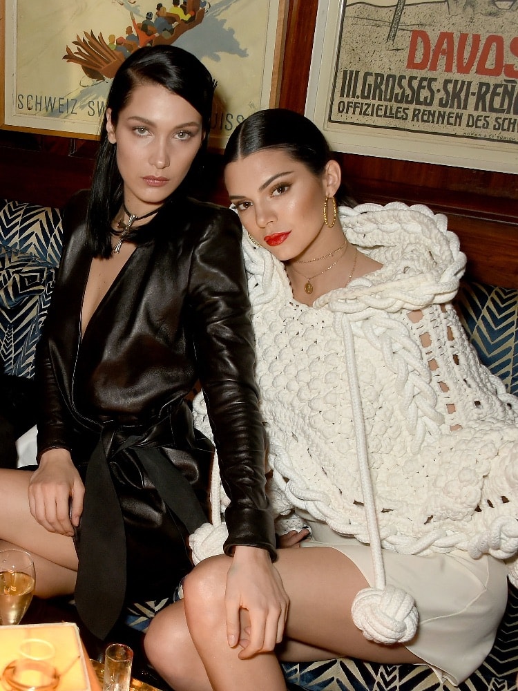 Bella Hadid (right) and Kendall Jenner (left), wearing Burberry Feb 2017 Couture cape at the LOVE and Burberry London Fashion Week Party at Annabel's