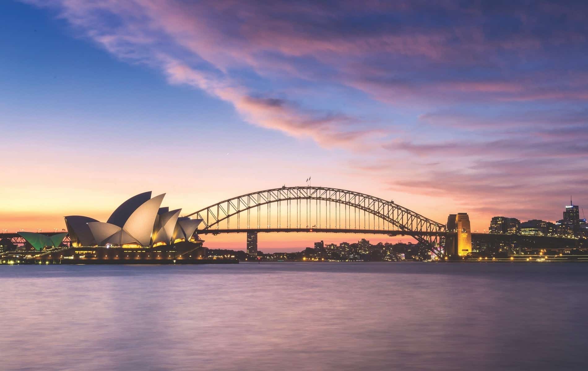 Evening light shines on the Sydney Opera House and Harbour Bridge in Sydney, Australia