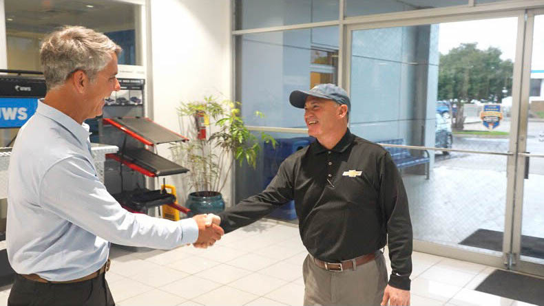 President, Shaking hands, inside dealership