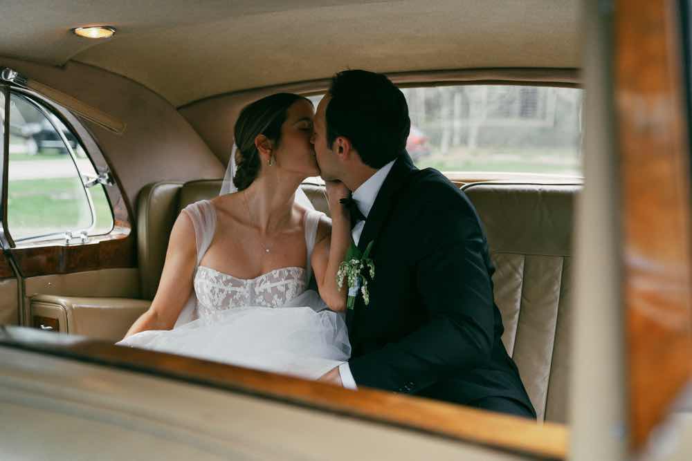 exit car interior shot, kiss, bride and groom